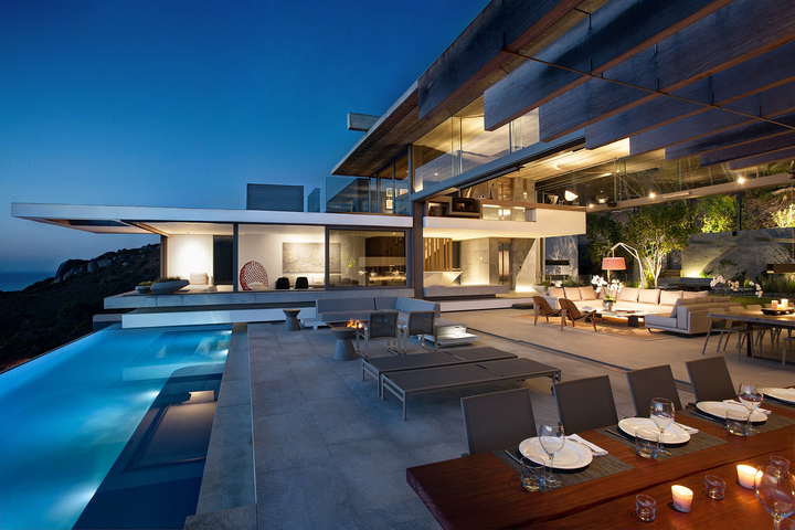 Private coastal villa with a pool at dusk