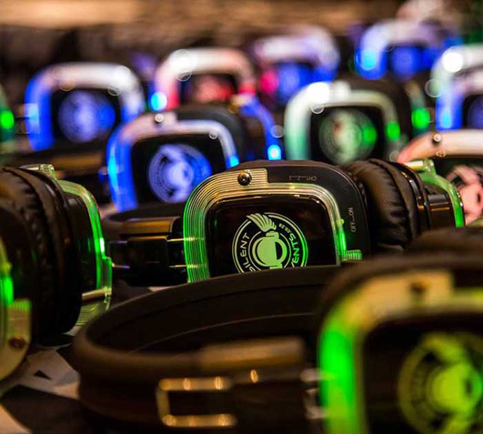 Rows of glowing silent disco headphones
