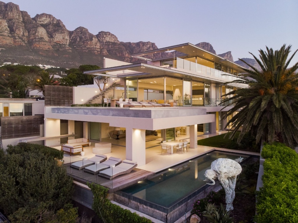 Private villa beneath the mountains at dusk